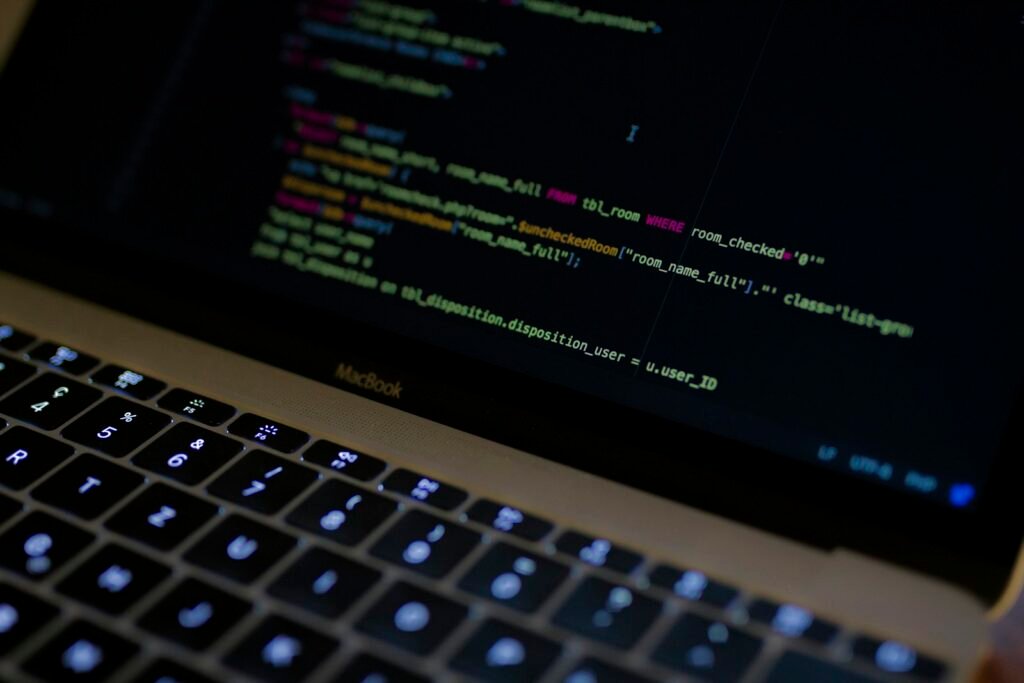 Laptop screen showing code, representing hands-on WooCommerce and Stripe checkout troubleshooting work